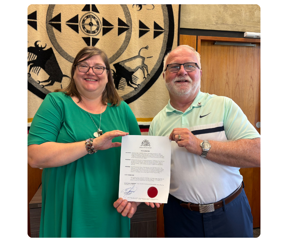 mitoAmbassador Alyson Maxwell and Mayor Ken Johnston of Red Deer with the World Mitochondrial Disease Week Proclamation 2025