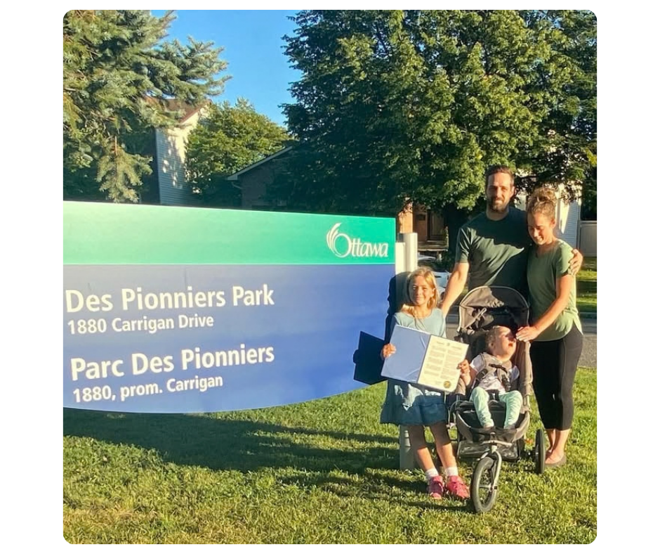 mitoAmbassador Kailey and her daughter Sloane of Ajax pose with the Ajax World Mitochondrial Disease Week 2025 Proclamation